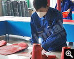  Worker is cutting wear-resistant rubber plate 